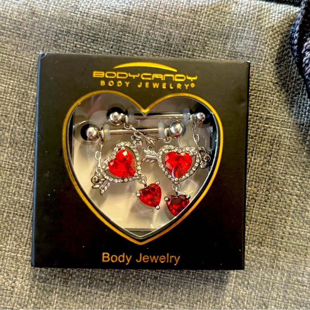 Brand new in the box. Heart jeweled body jewelry